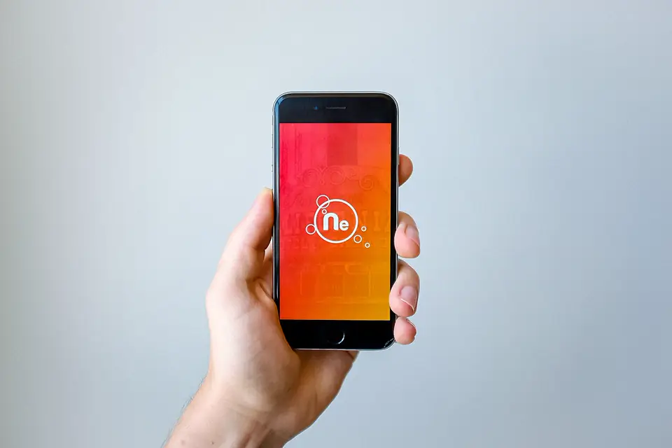 A hand holding a smartphone